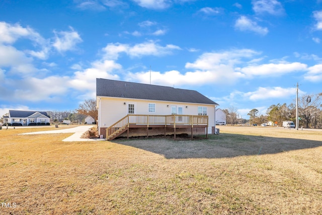 back of property featuring a yard and a wooden deck