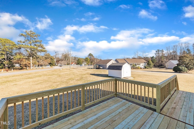 wooden deck with a shed and a yard