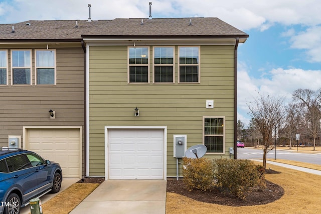 back of property featuring a garage