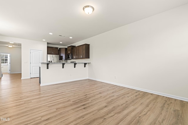 unfurnished living room featuring light hardwood / wood-style floors