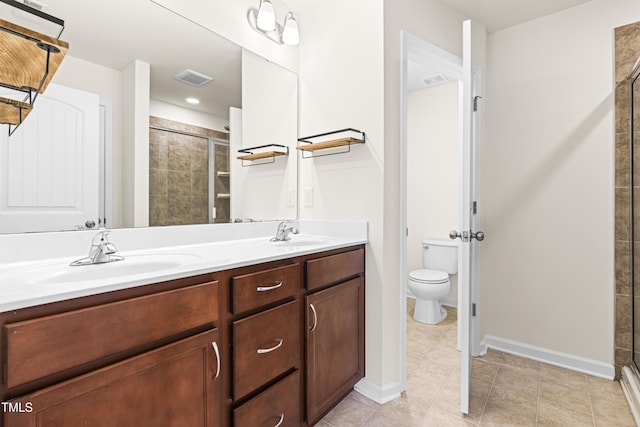 bathroom with toilet, vanity, and an enclosed shower