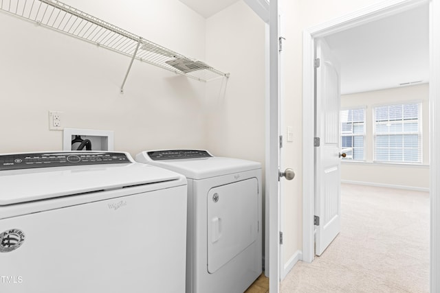 washroom featuring light colored carpet and washer and dryer