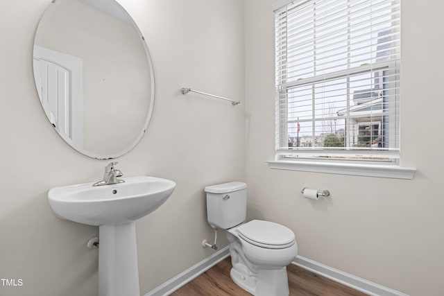 bathroom featuring sink, hardwood / wood-style floors, and toilet