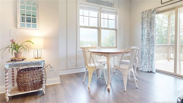 dining space with a healthy amount of sunlight and hardwood / wood-style floors