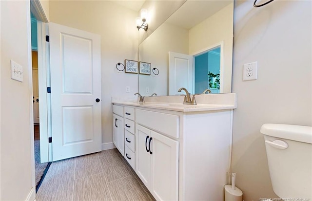 bathroom featuring toilet and vanity