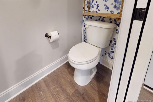 bathroom featuring toilet and wood-type flooring