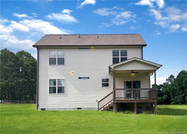 rear view of house featuring ceiling fan, a yard, and a wooden deck