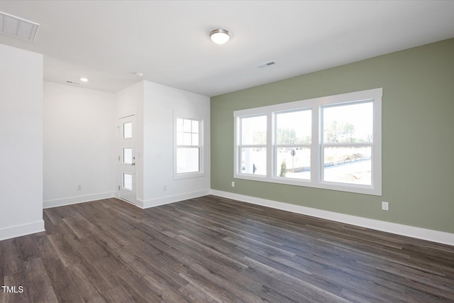 unfurnished living room featuring dark wood-type flooring