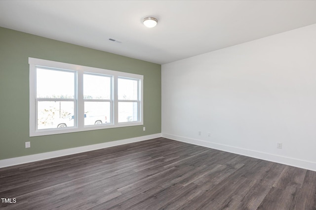 empty room with dark wood-type flooring