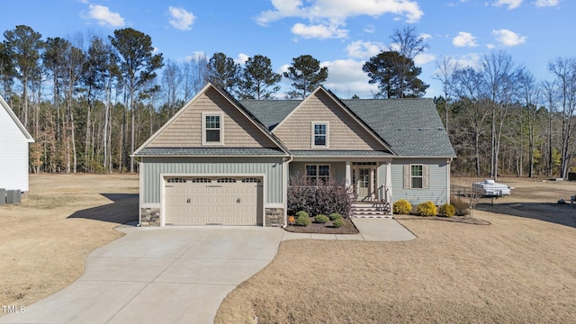 craftsman inspired home with a garage and covered porch