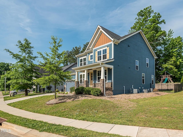 craftsman-style house featuring a porch, board and batten siding, and a playground