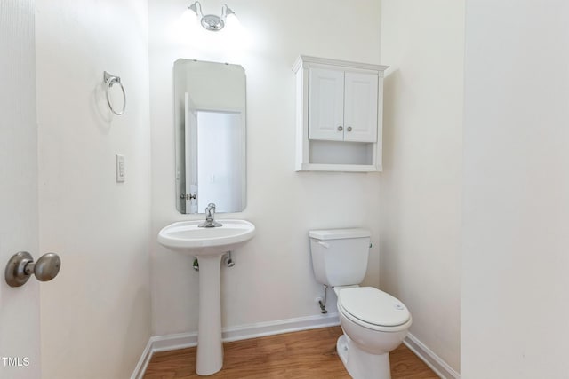 bathroom featuring hardwood / wood-style flooring, sink, and toilet