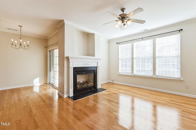 unfurnished living room featuring light hardwood / wood-style floors, ceiling fan with notable chandelier, and ornamental molding