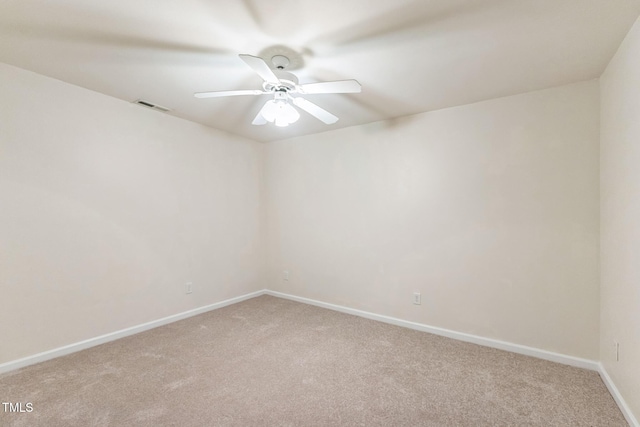 spare room with light colored carpet and ceiling fan