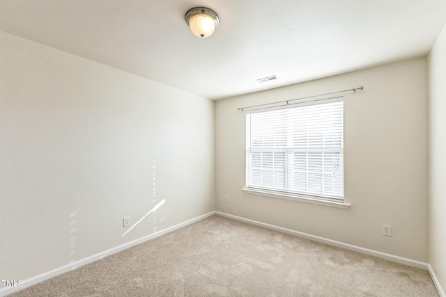 spare room with light colored carpet