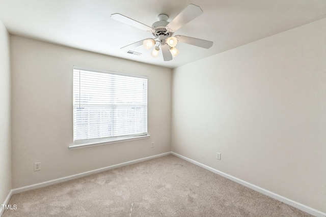 unfurnished room featuring ceiling fan and light carpet