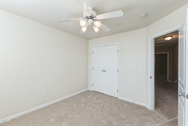 unfurnished bedroom with light colored carpet, a closet, and ceiling fan