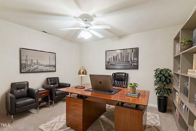 carpeted office featuring ceiling fan