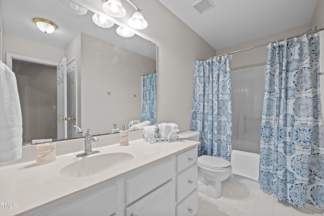 bathroom featuring vanity, tile patterned floors, and toilet