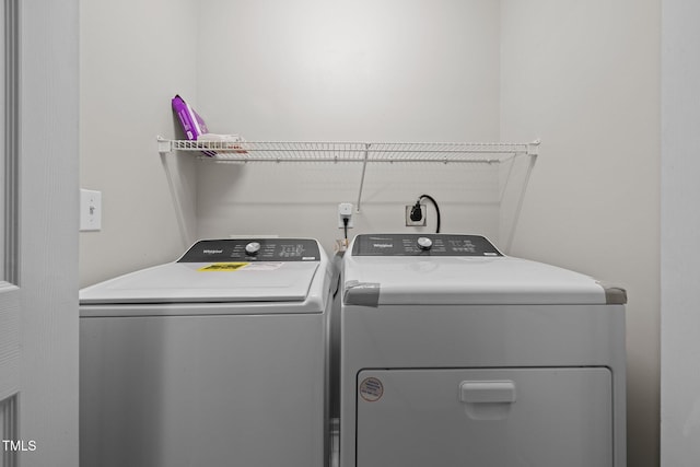 washroom featuring washer and clothes dryer