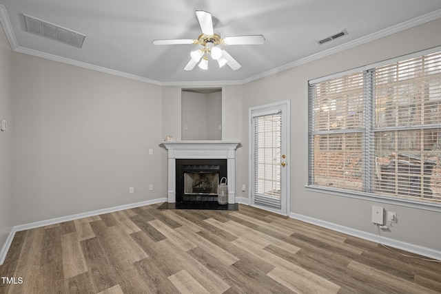 unfurnished living room with crown molding, ceiling fan, and wood-type flooring