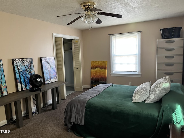 bedroom with ceiling fan, a closet, a textured ceiling, and dark colored carpet