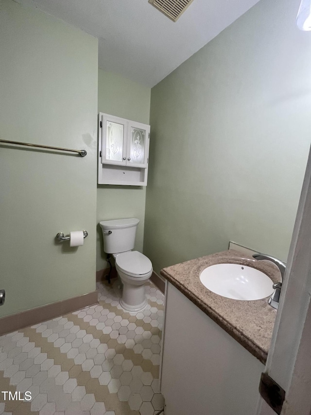 bathroom featuring toilet and vanity