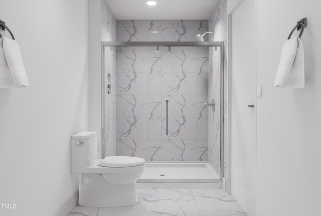 bathroom featuring an enclosed shower and toilet