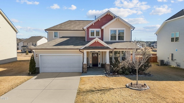 craftsman-style home with central air condition unit and a garage