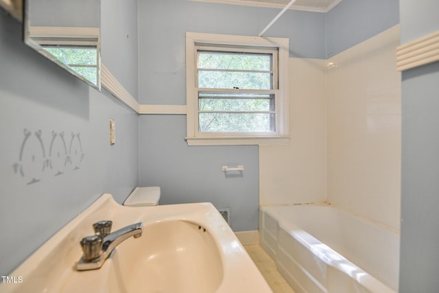 full bathroom with sink, shower / bath combination, and toilet