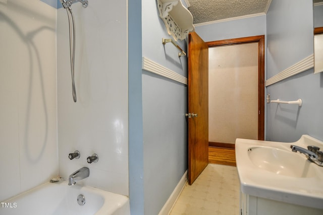 bathroom featuring shower / bathing tub combination, vanity, crown molding, and a textured ceiling