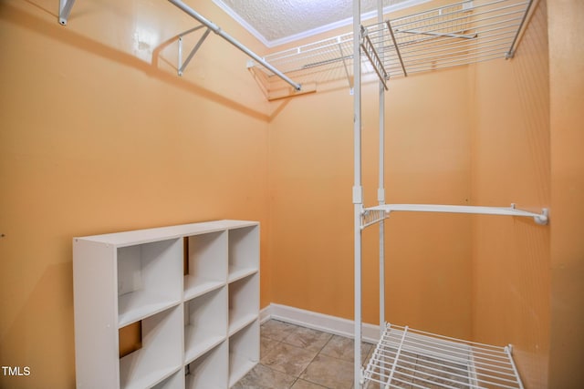 walk in closet with tile patterned flooring