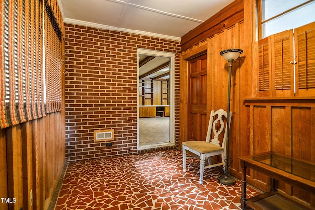 interior space with wood walls and ornamental molding