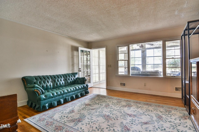 living room with hardwood / wood-style floors and a textured ceiling