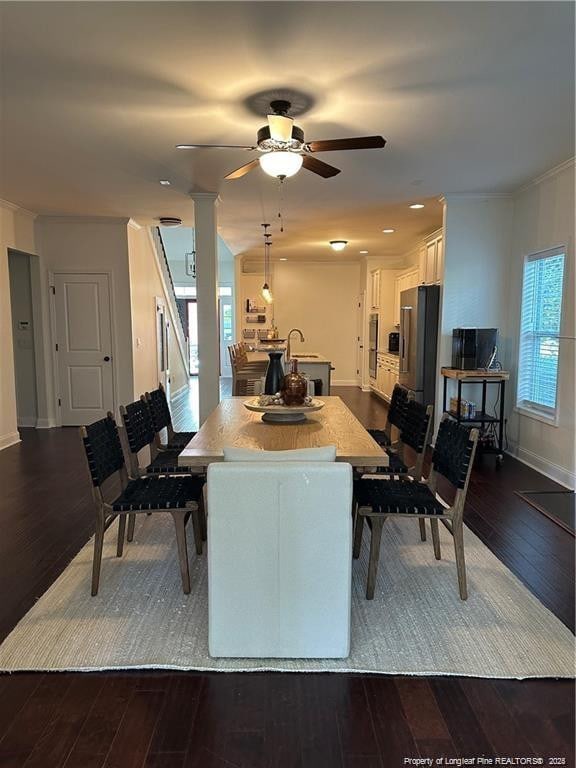 dining room featuring ceiling fan and dark wood-type flooring