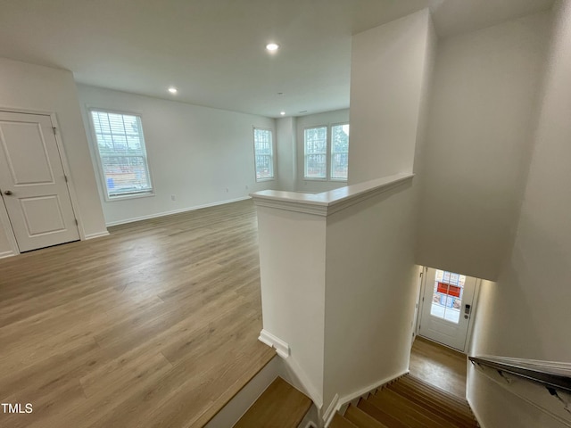 stairs featuring hardwood / wood-style floors