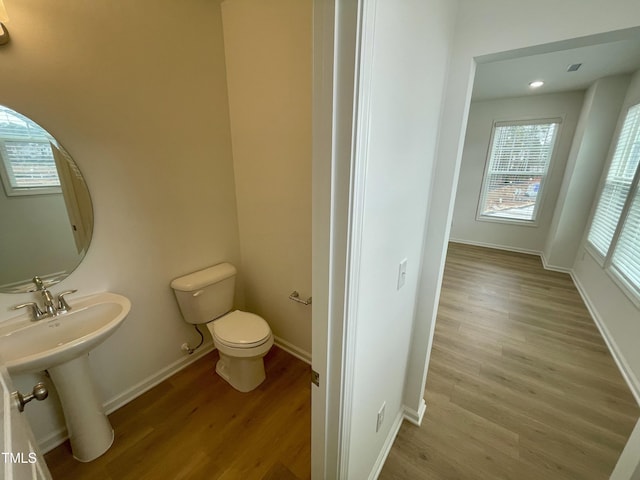 bathroom featuring wood-type flooring and toilet