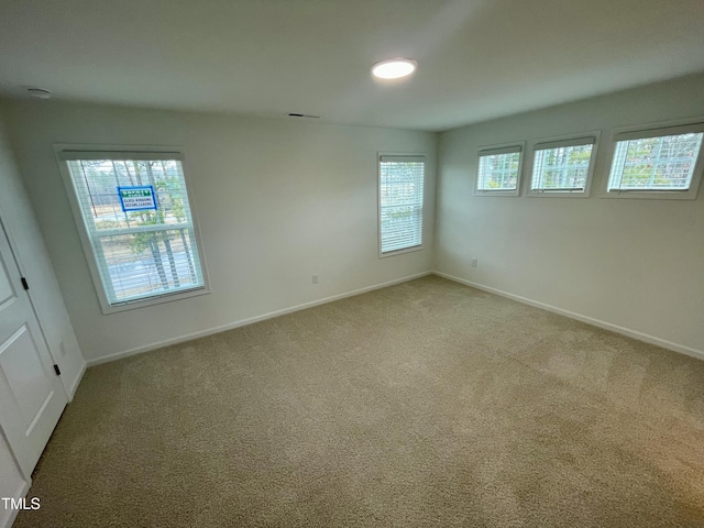 unfurnished room with plenty of natural light and carpet flooring