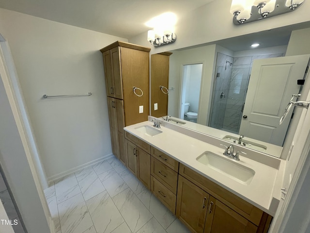 bathroom with toilet, vanity, and walk in shower