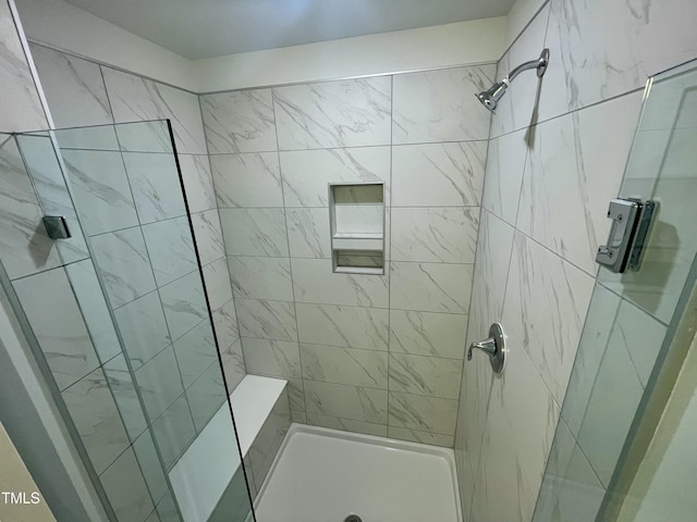 bathroom featuring tiled shower