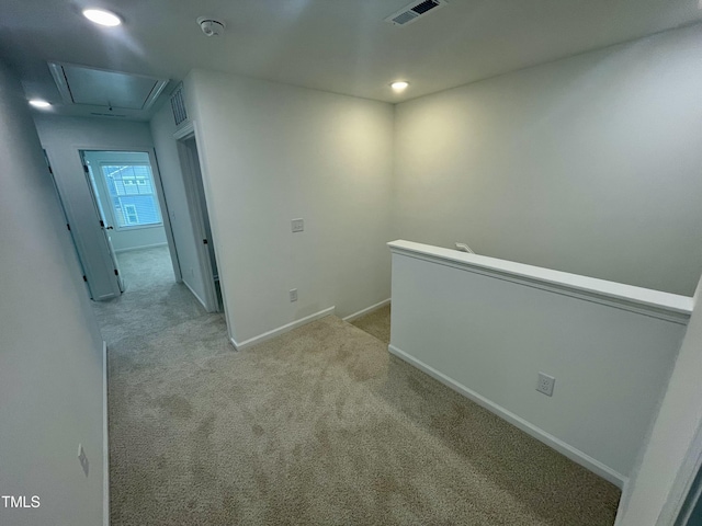 corridor featuring light colored carpet