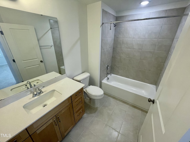 full bathroom featuring toilet, tiled shower / bath, and vanity