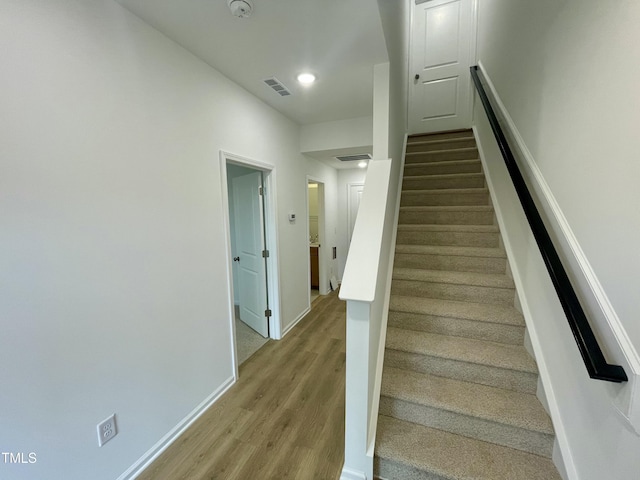 staircase with wood-type flooring