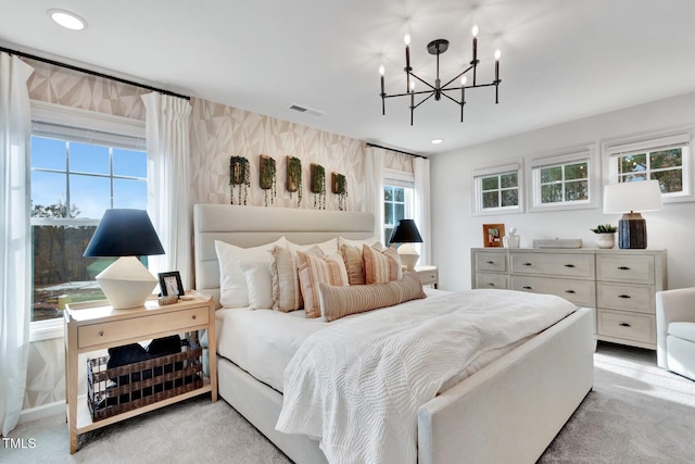 bedroom with light carpet and a notable chandelier