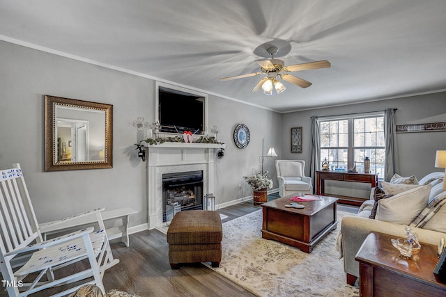 living room featuring crown molding, ceiling fan, and dark hardwood / wood-style flooring