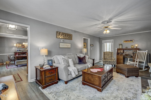 living room with ceiling fan, light hardwood / wood-style flooring, and crown molding