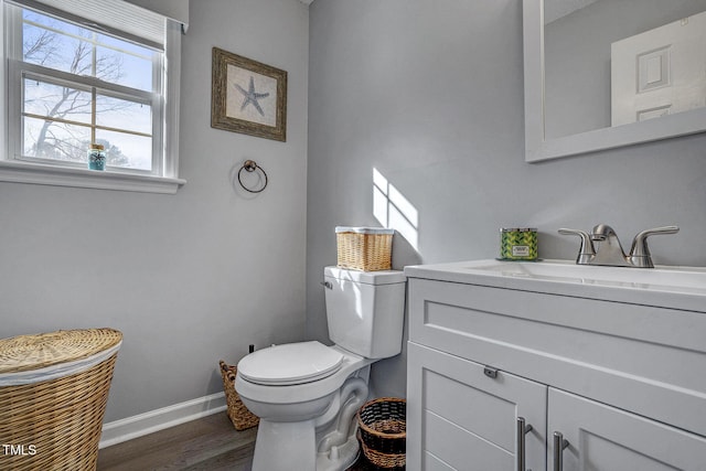 bathroom featuring vanity, toilet, and wood-type flooring