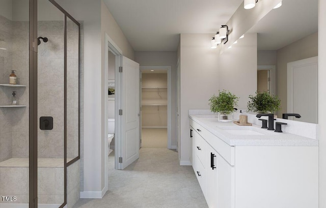 bathroom featuring vanity, toilet, and an enclosed shower