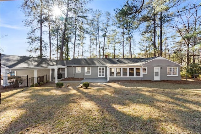 rear view of property with a patio area and a lawn