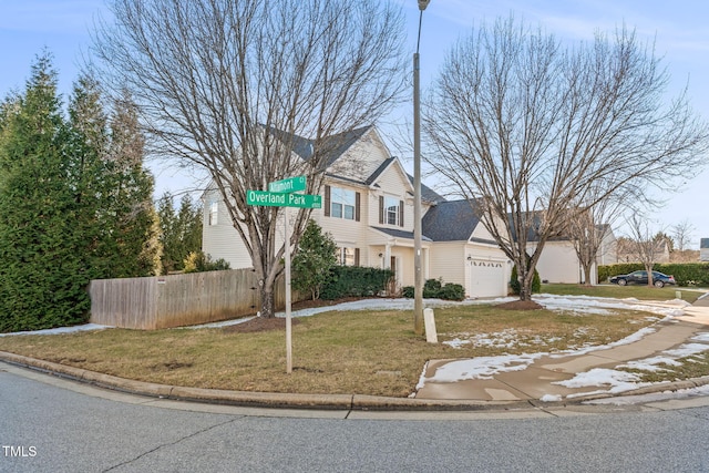 view of front of property with a front lawn and a garage